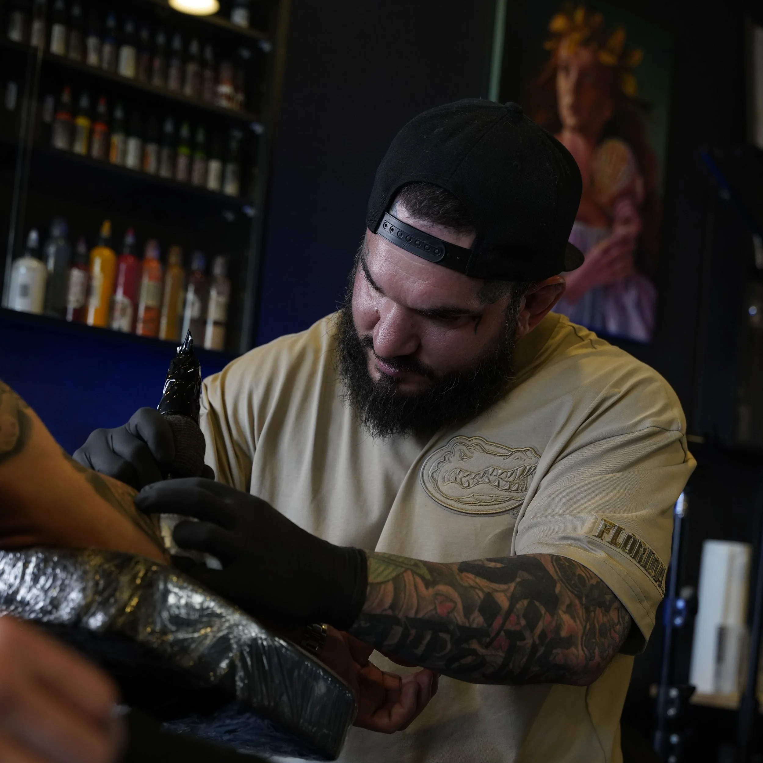 Adrian Aguirre working on a tattoo at Black Nova Tattoo Collective in Miami.