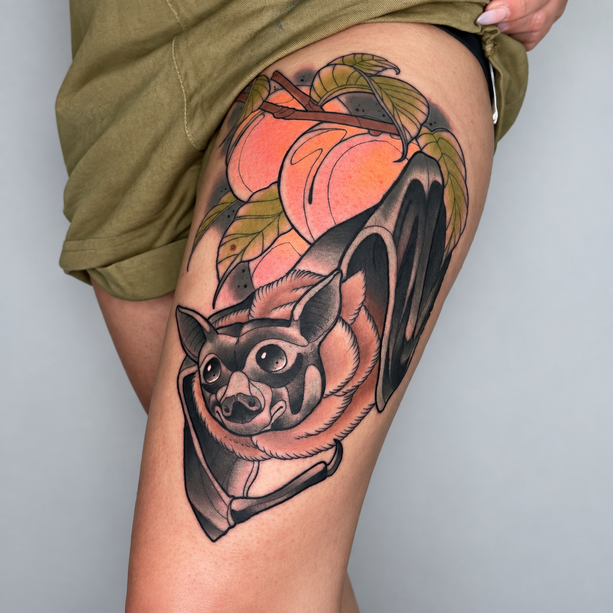 Neo-traditional skull and fruit thigh tattoo by Adrian Aguirre.