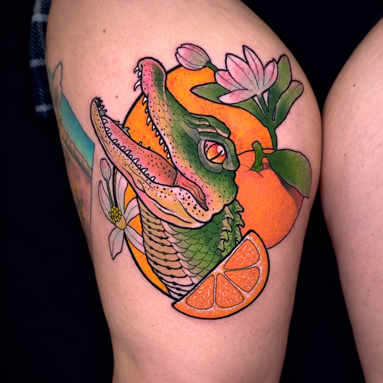 Neo-traditional fruit and leaf tattoo in orange and green by Adrian Aguirre.