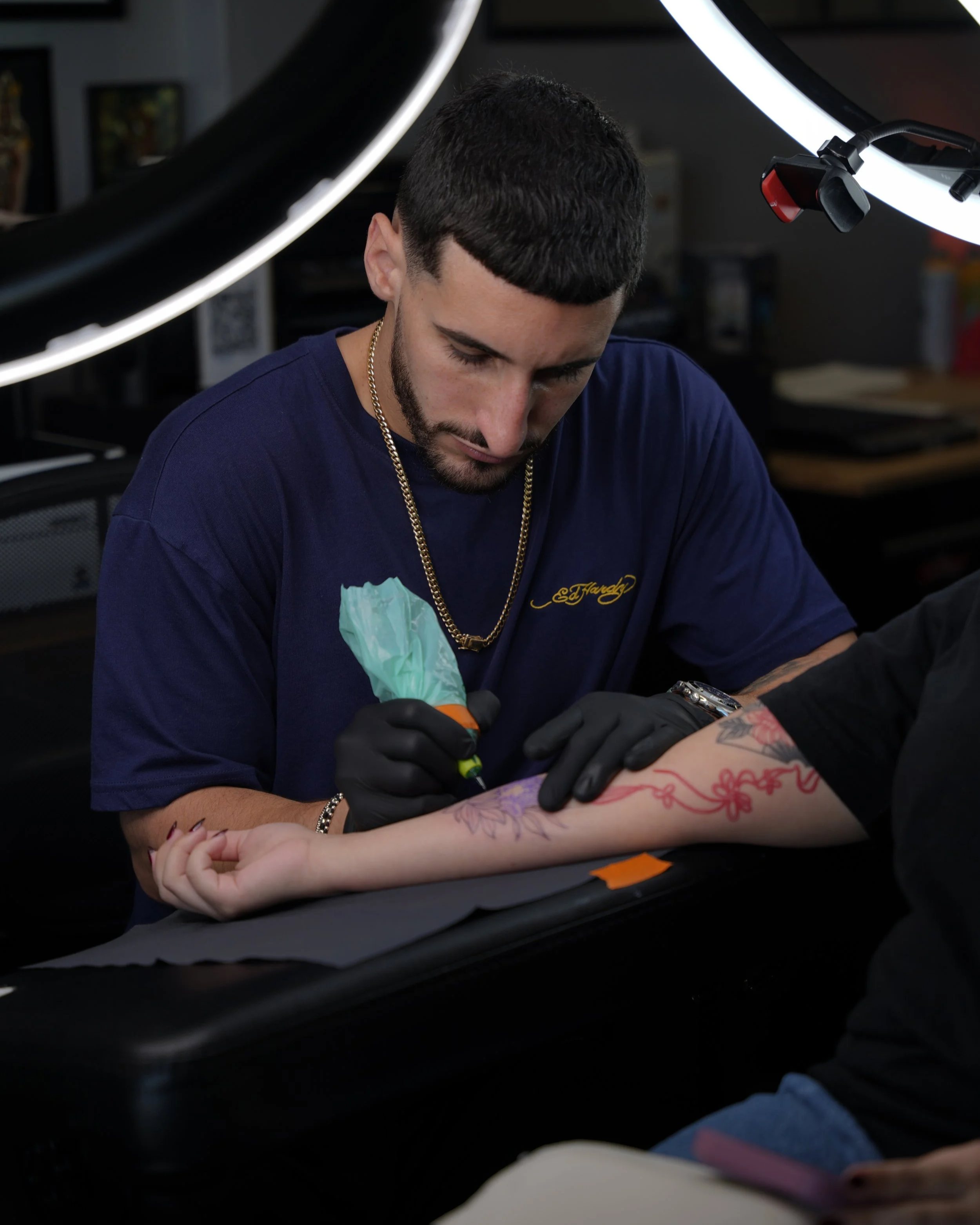 Portrait of Sandy, fine line and black & grey realism tattoo artist at Black Nova Tattoo Collective in Miami, creating custom tattoos with precision and attention to detail.
