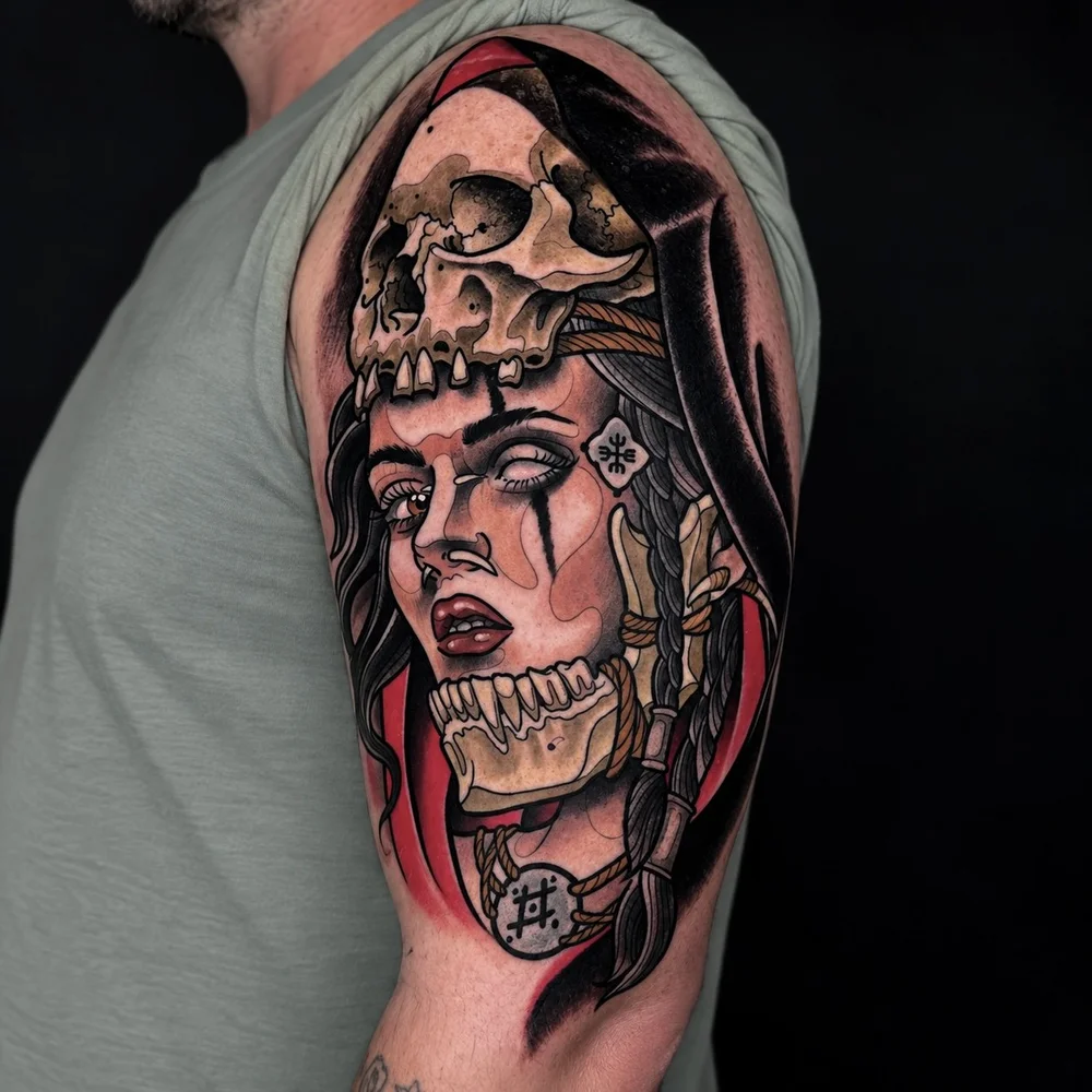 Neo-traditional woman and skull upper-arm tattoo by Adrian Aguirre.