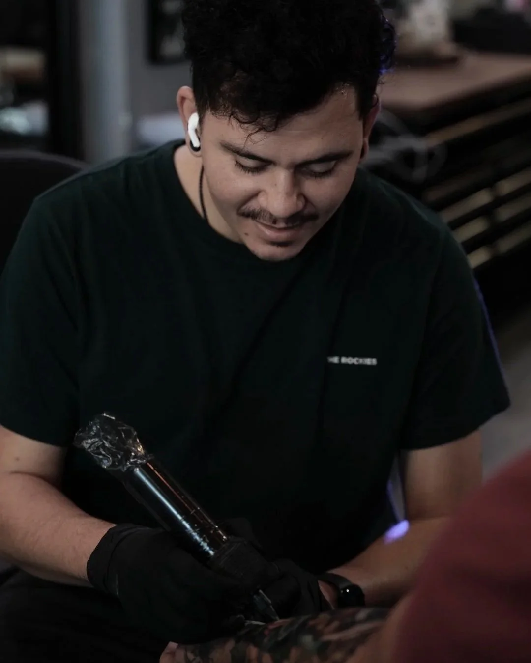 Portrait of Yorlandi Fabregas, cover-up and color realism tattoo artist at Black Nova Tattoo Collective in Miami, specializing in Japanese concept tattoos and large-scale custom projects.