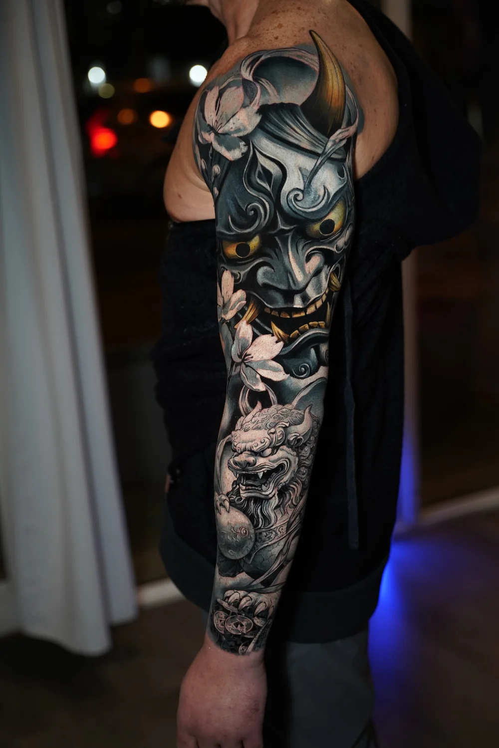 Japanese-inspired color sleeve tattoo featuring a Hannya mask, dragon, cherry blossoms, and ornamental details by Yorlandi Fabregas at Black Nova Tattoo Collective in Miami.
