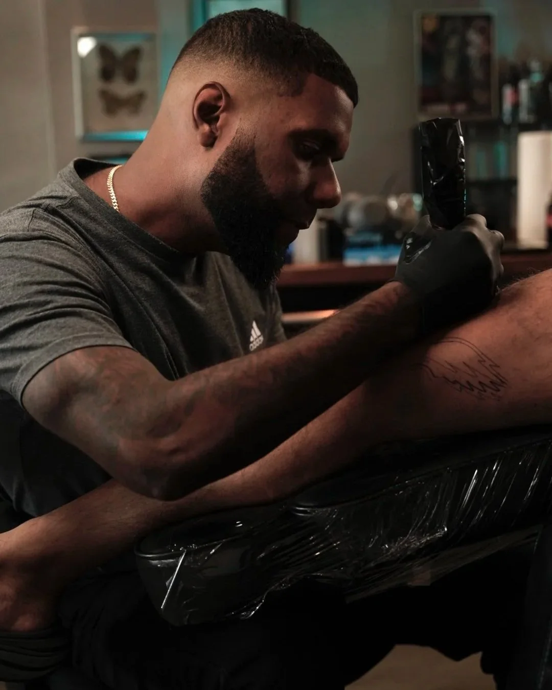 Portrait of Luis Dajer, black & grey realism and fine line tattoo artist at Black Nova Tattoo Collective in Miami, specializing in custom tattoos and detailed realism work.
