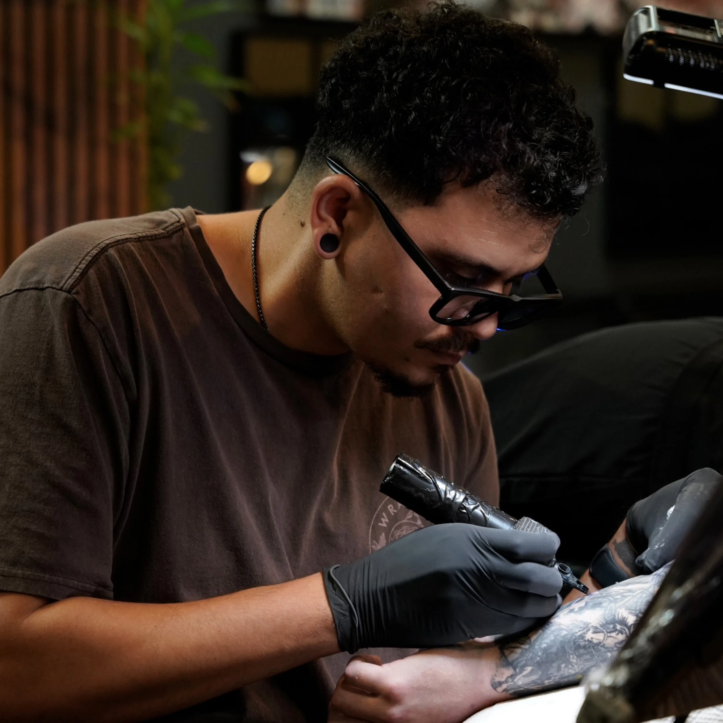 Yorlandi Fabregas working on a custom tattoo at Black Nova Tattoo Collective in Miami.