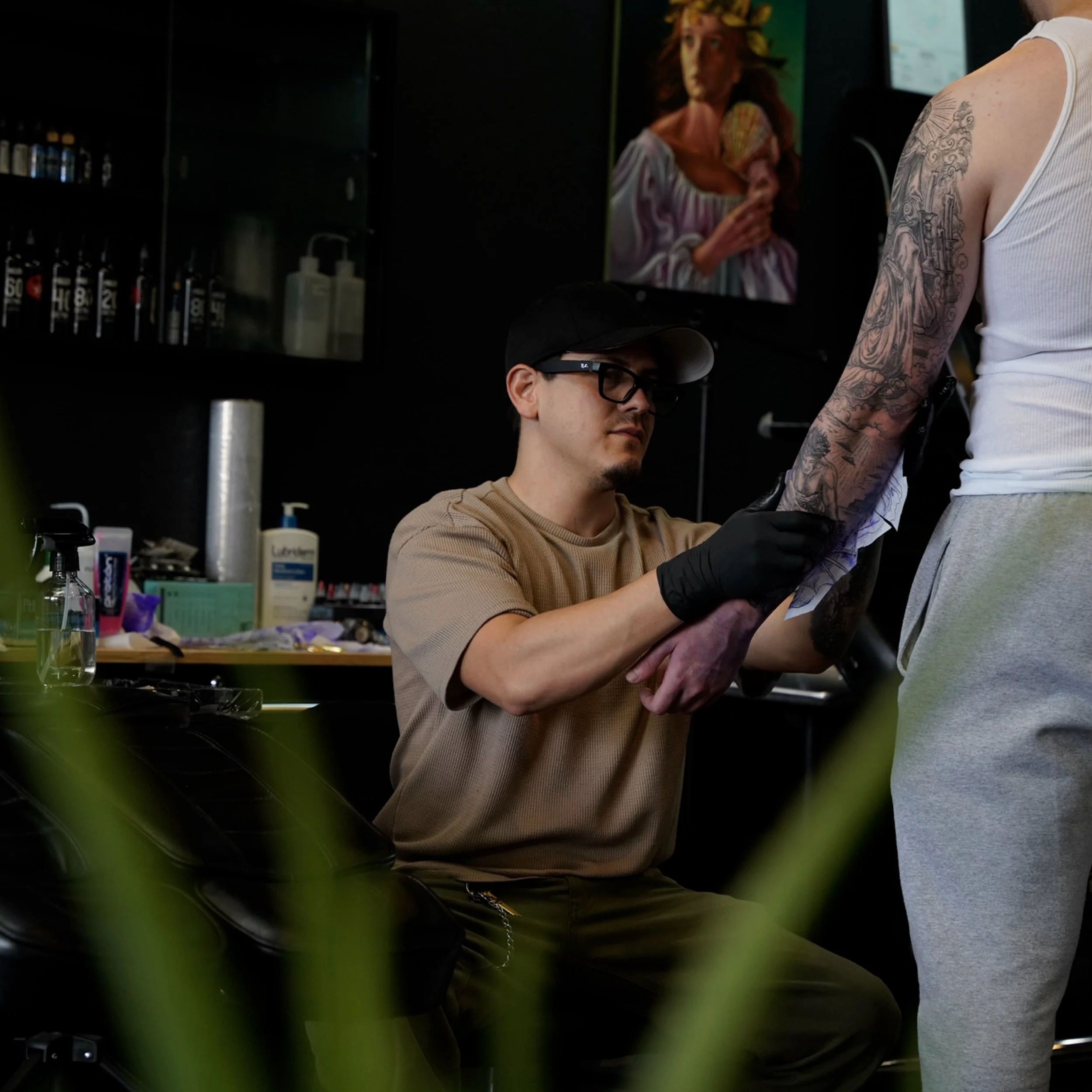 Alexis Torres working on an arm tattoo at Black Nova Tattoo Collective in Miami.