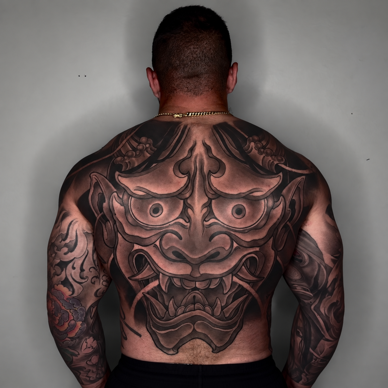 Large black and grey ornamental back tattoo by Adrian Aguirre.