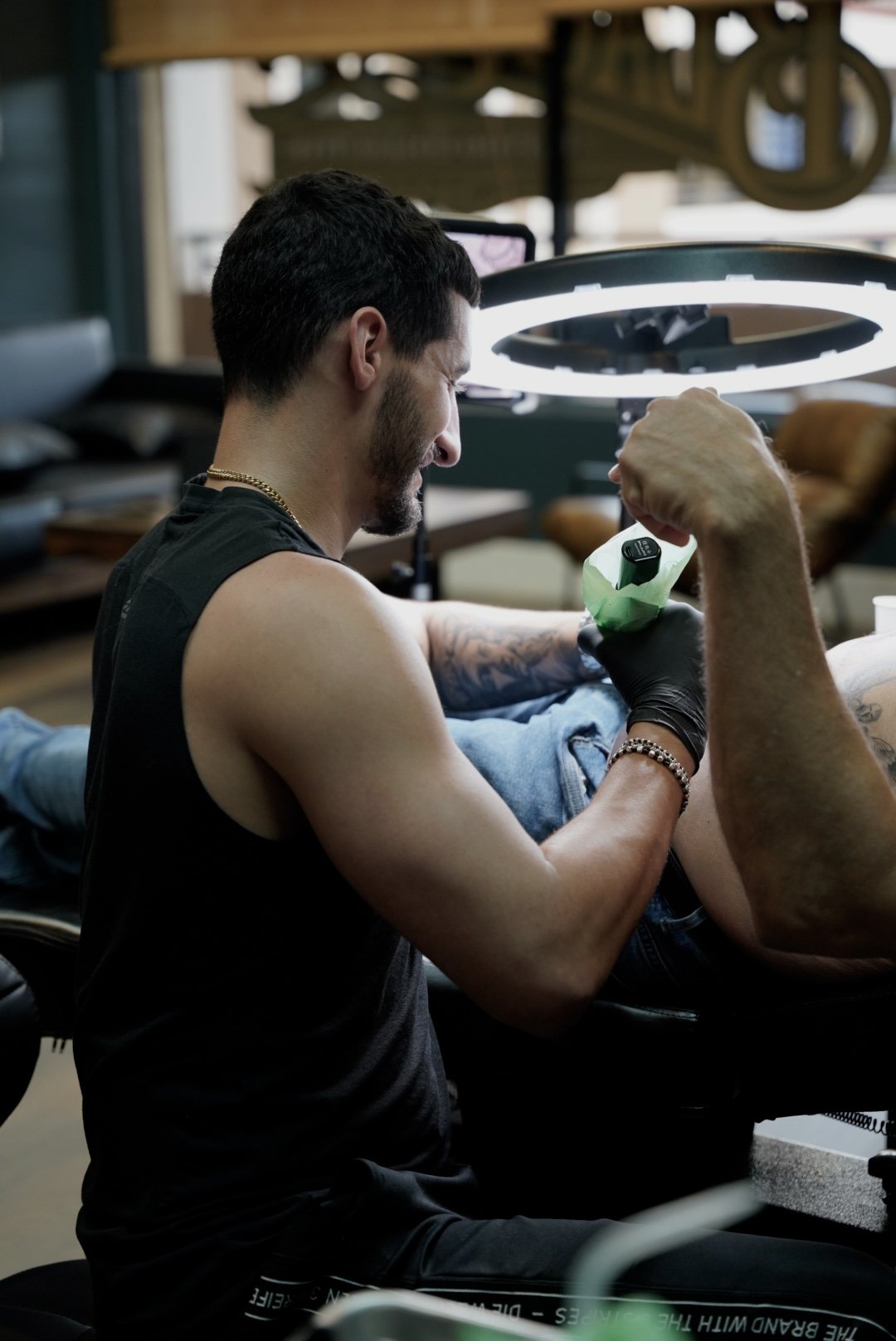 Tattoo artist working on a custom tattoo at Black Nova Tattoo Collective in Miami, showcasing precision, creativity, and the professional studio environment.