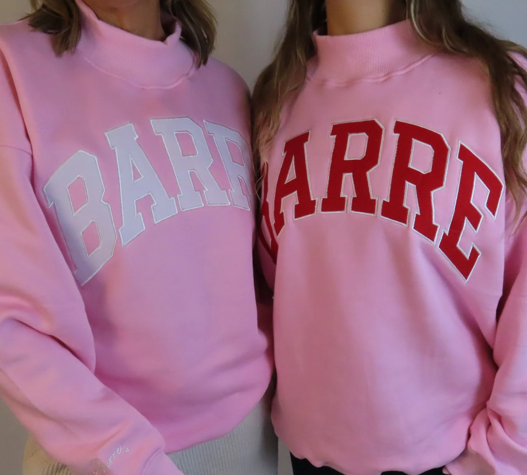 Two women wearing pink sweatshirts with the word 'PARTY' displayed in large white and red block letters across their chest, standing close together.