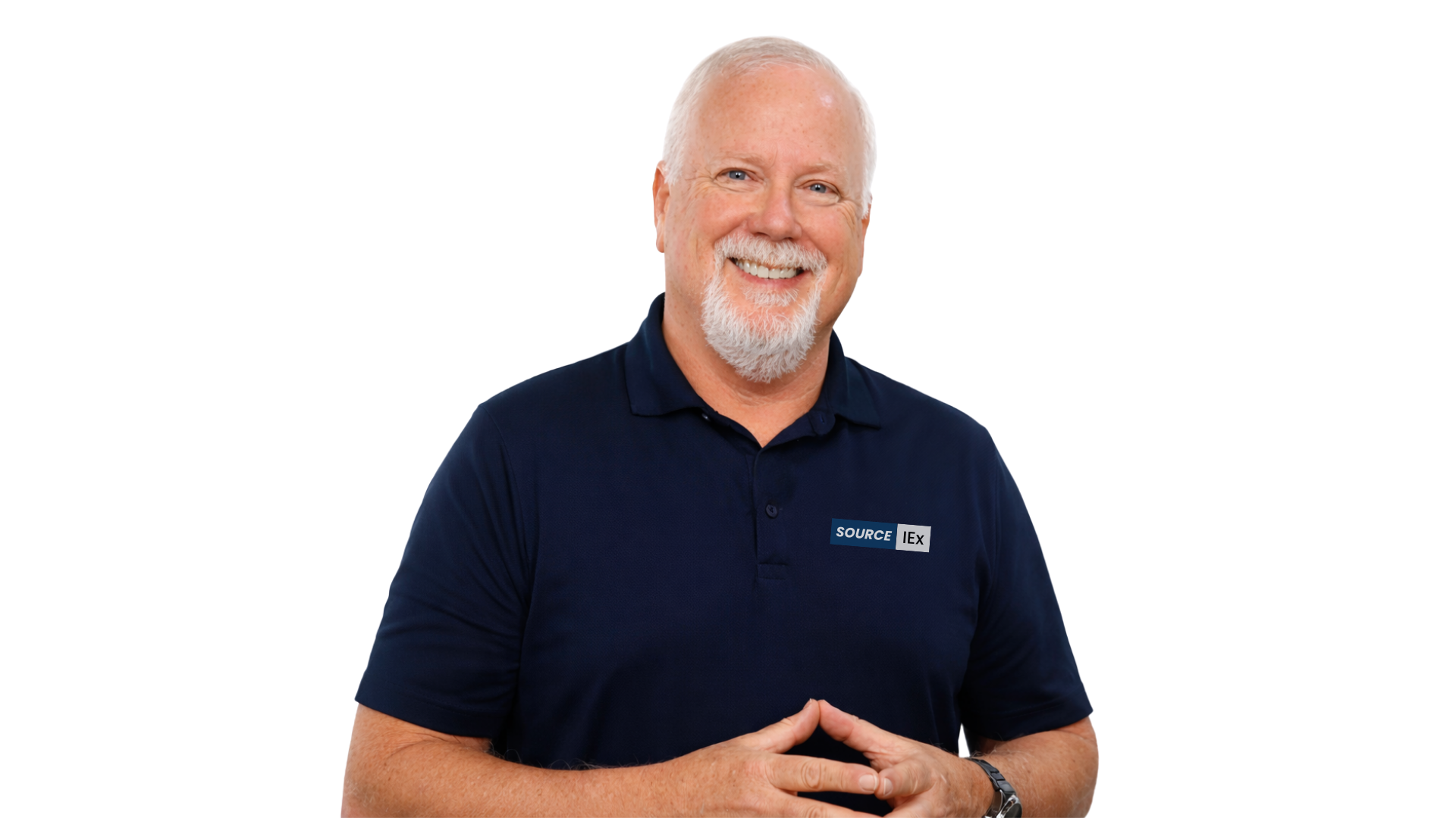 A smiling middle-aged man with a white beard and short white hair, wearing a navy blue polo shirt with a 'SOURCE IEX' logo, stands with his hands folded in front of him against a transparent background.