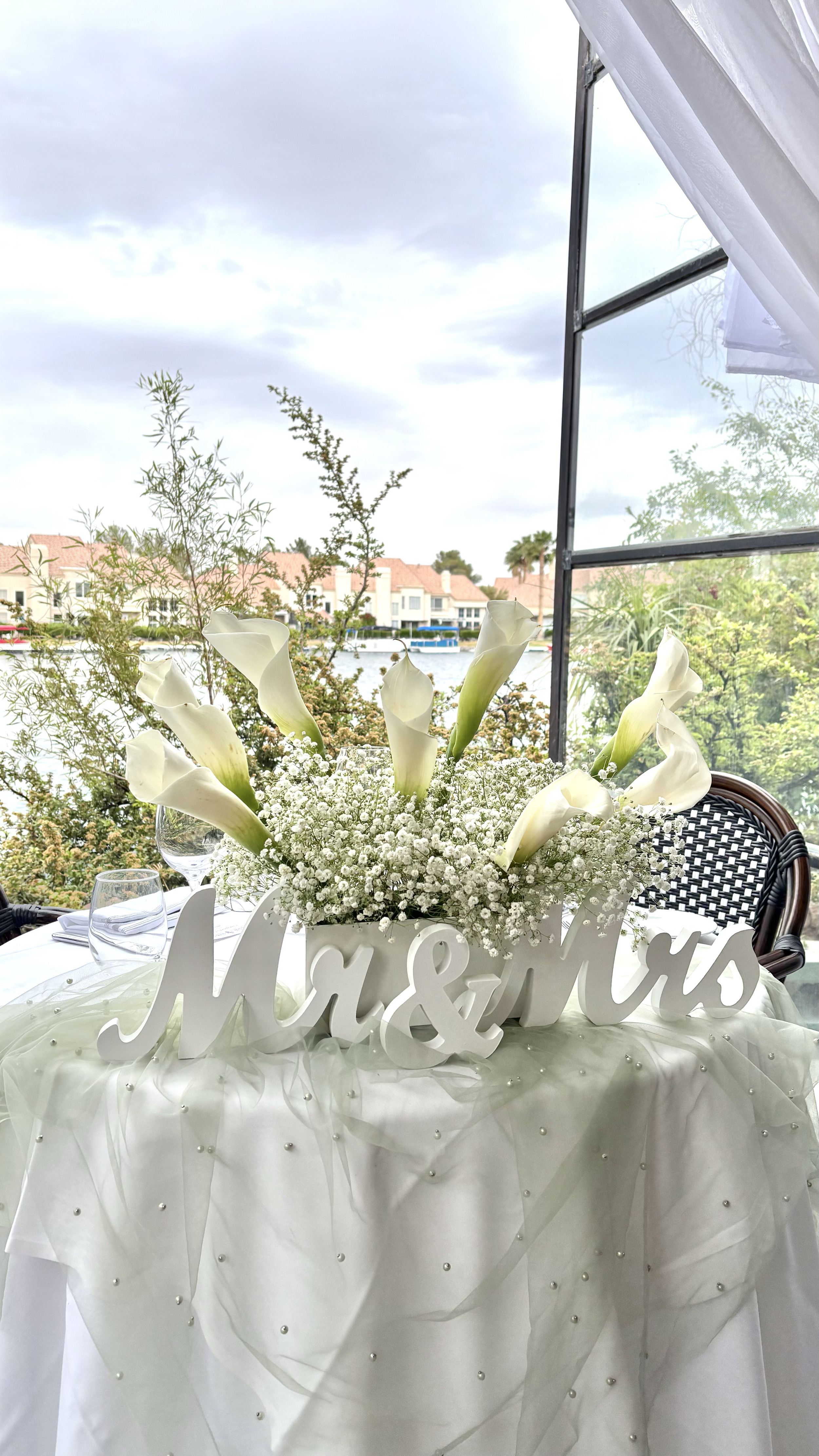 Luxury wedding head table with elegant white calla lilies and baby’s breath floral arrangement designed by Marie Events in Las Vegas.