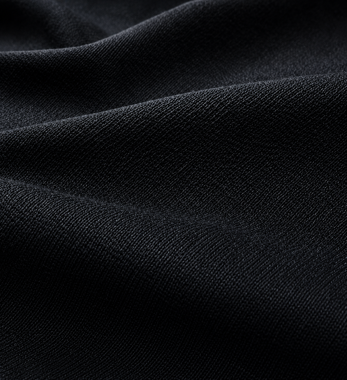 Close-up photograph of black textured fabric with fine weave and slight sheen.