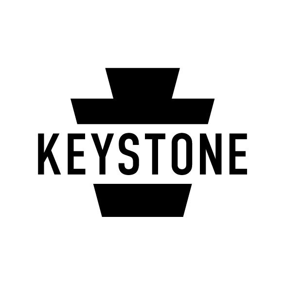 Black and white logo with the word 'KEYSTONE' in bold capital letters, integrated into a geometric design resembling a keystone or architectural element.