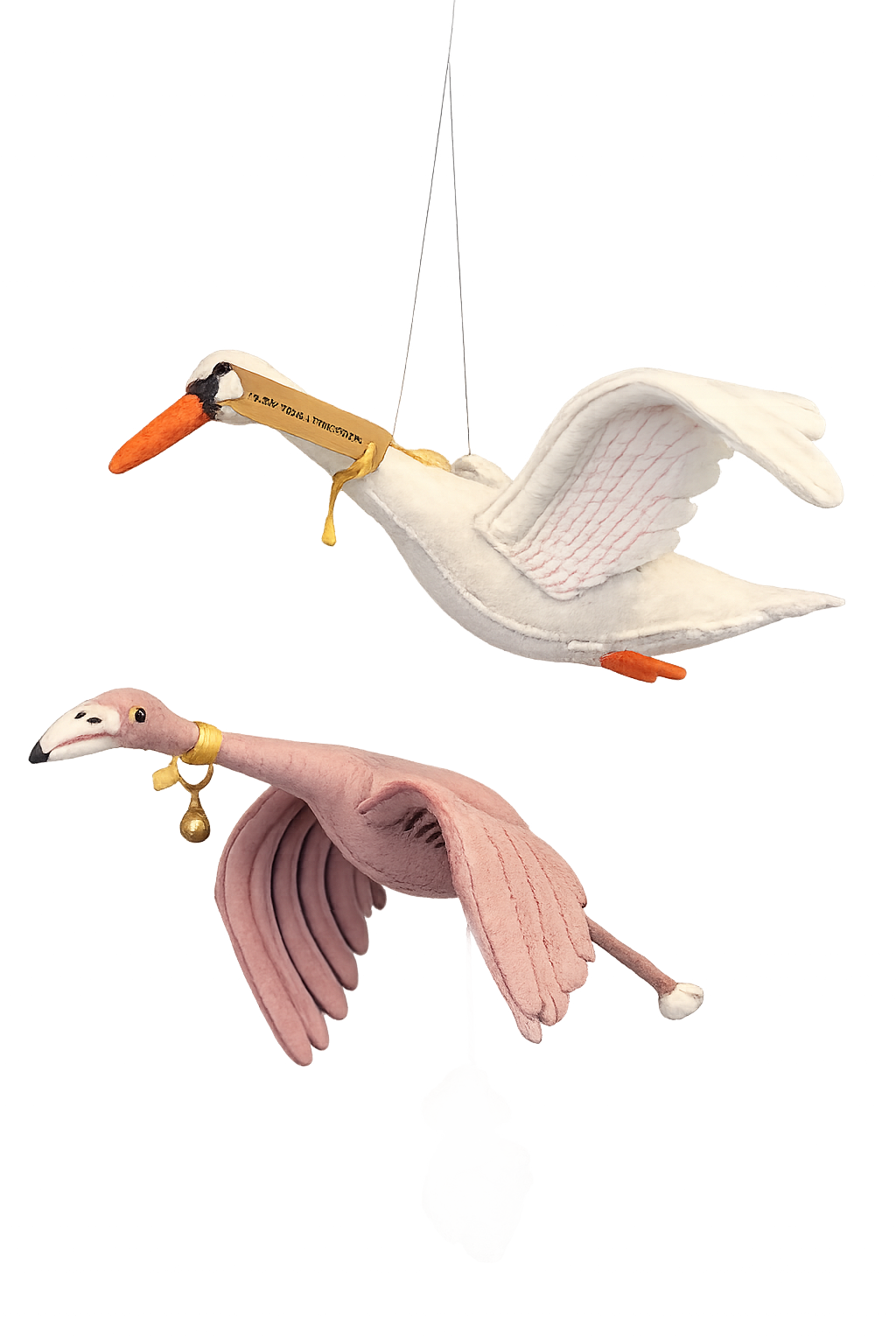 Two plush bird toys, one resembling a white stork and the other a pink flamingo, decorated with ribbons and small ornaments, with a rock near the flamingo's feet.