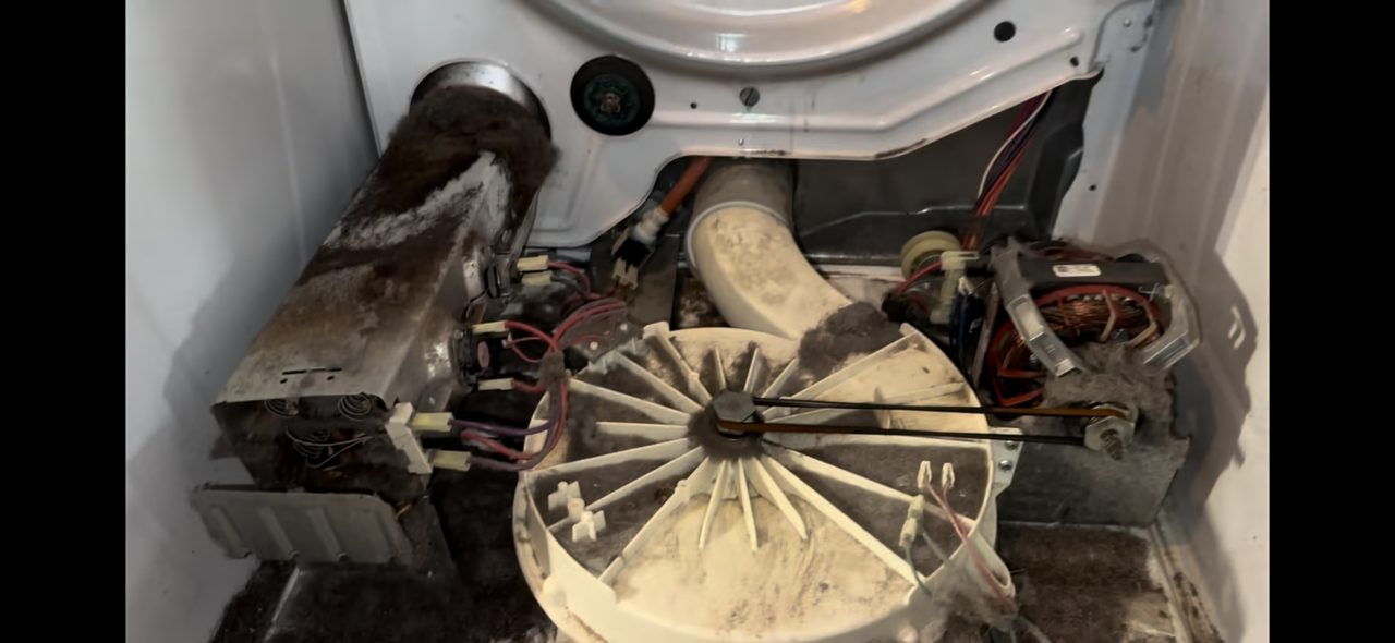 Interior view of a dryer with lint built up causing the dryer not to heat