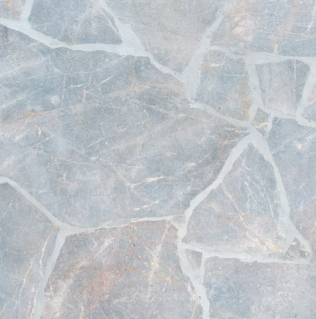 Close-up view of a stone or marble tile surface with a grayish-blue color and natural veining.