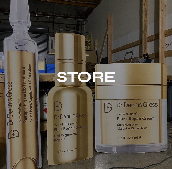 Display of Dr. Dennis Gross skincare products including a pump tube, a serum bottle, and a cream jar, arranged on a shelf in a store or warehouse setting.