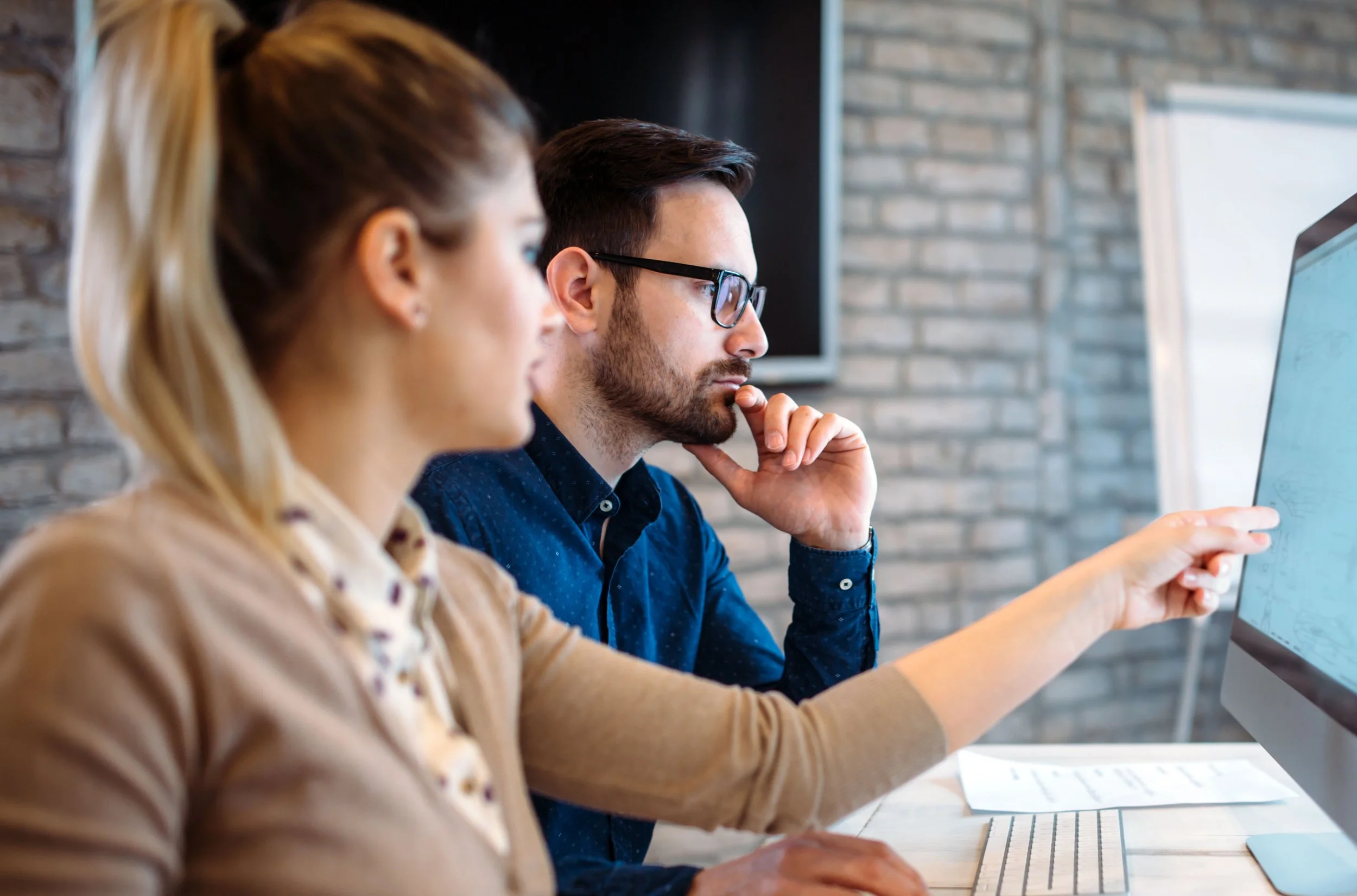 Man and Woman sitting at desk