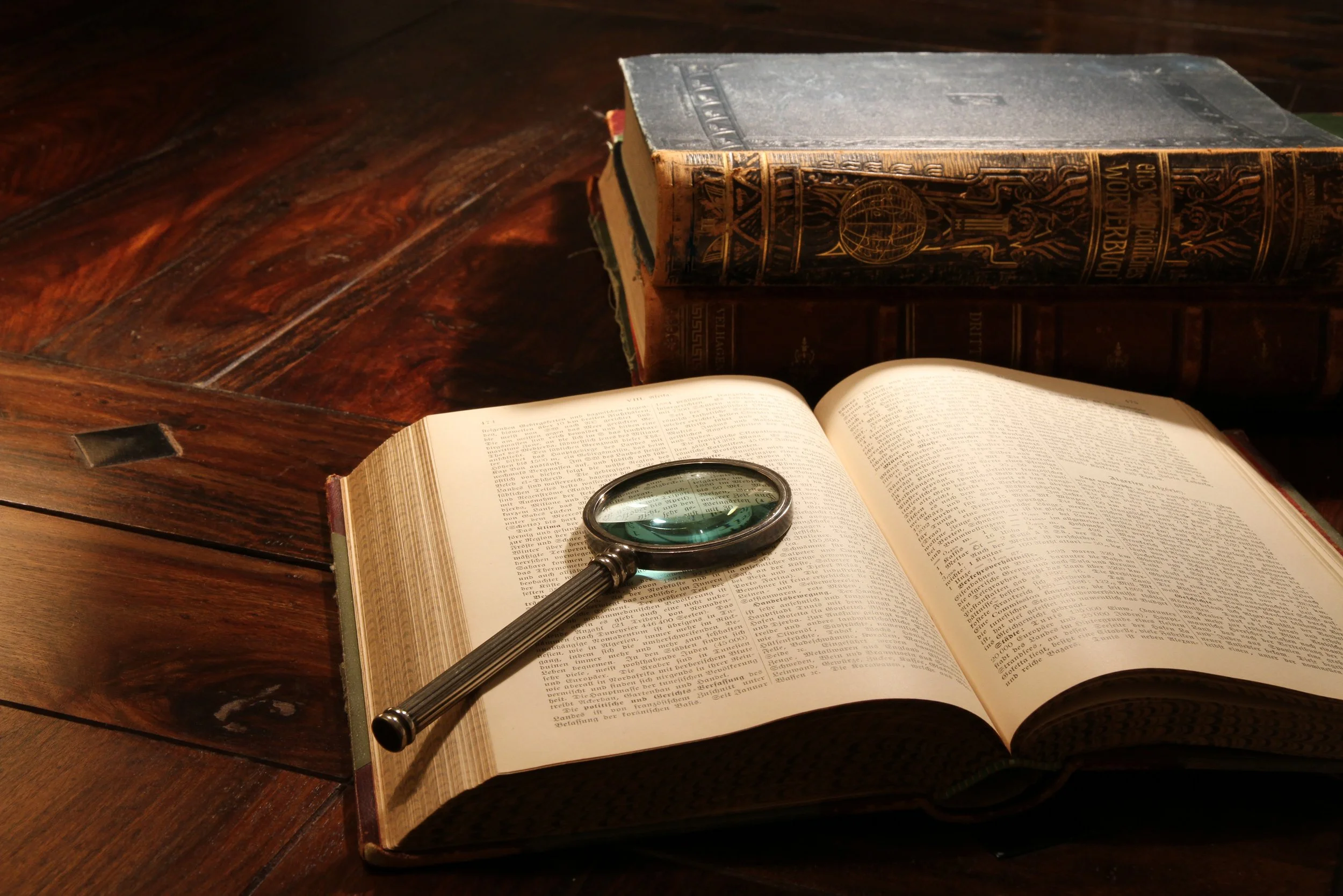 Magnifying glass and legal books on an old desk