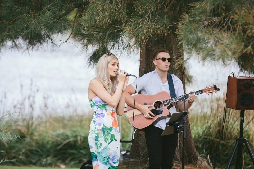 The Sweet Country Gal and acoustic guitarist performing live as a duo at a Queensland outdoor wedding