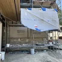 Construction site with scaffolding and a partially covered building