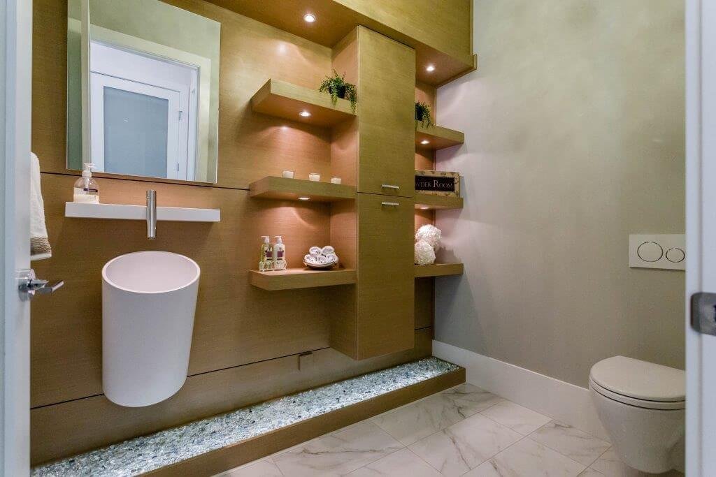 Modern bathroom with wooden shelves, a white ceramic urinal, a mirror, and beige walls.