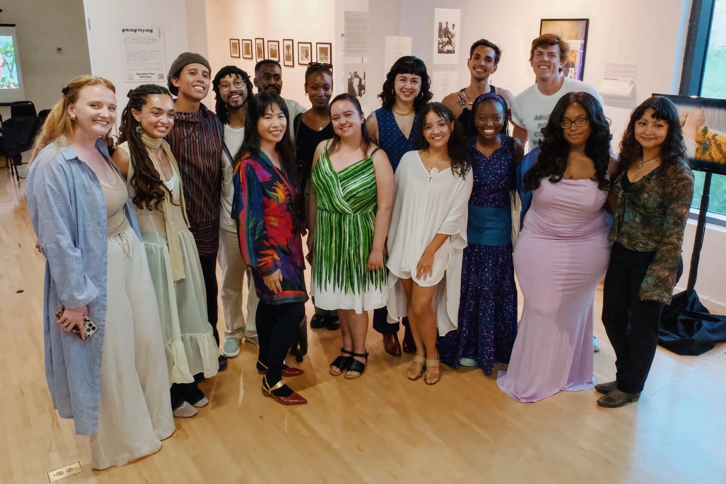 Climate futures studio cohort II, posing together indoors for a photo in front of art on the walls.