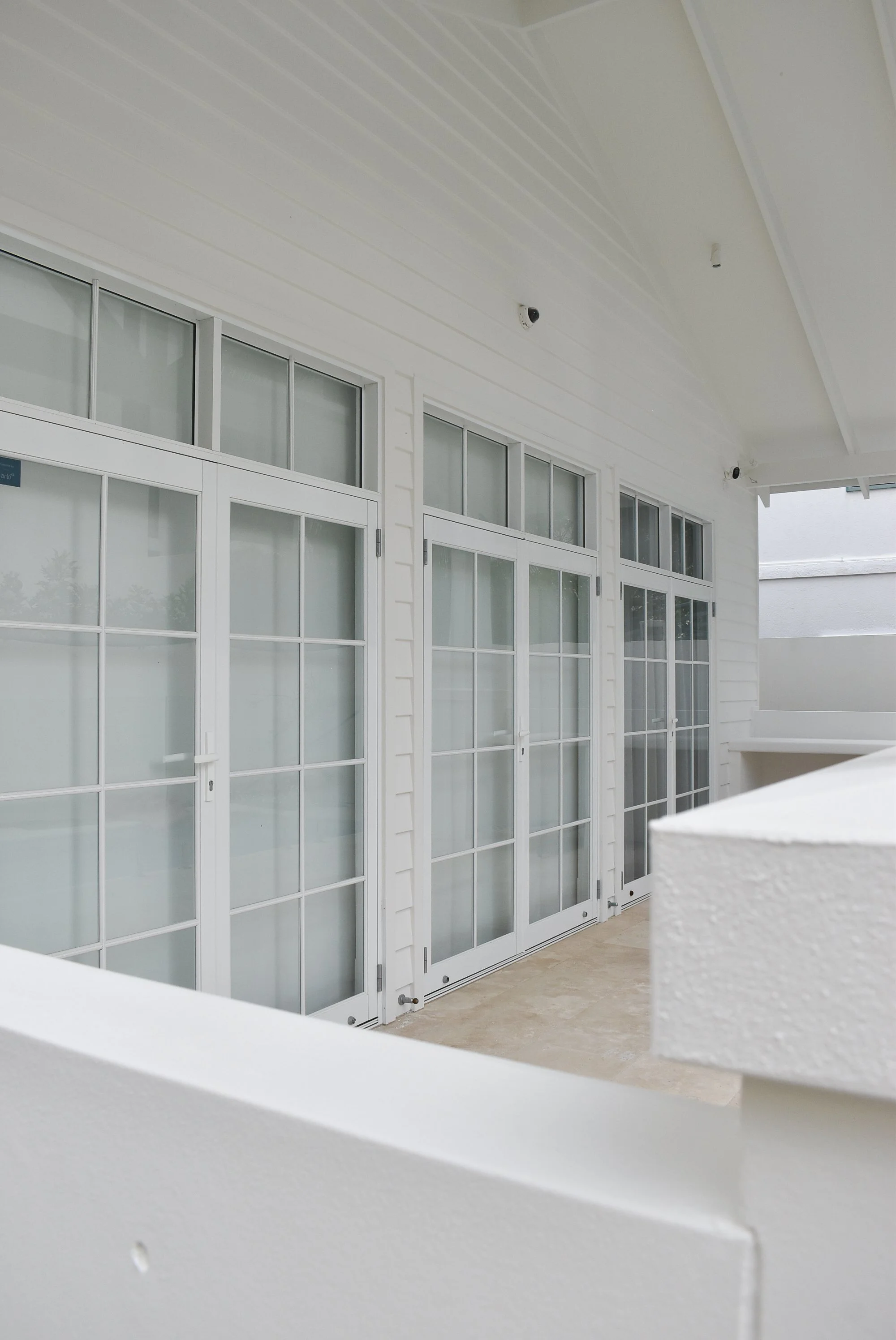 Person applying sealant around a window frame.