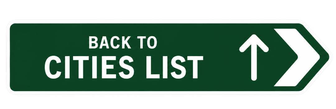 Green highway sign with white text that reads 'Back to Cities List' and an arrow pointing upward to the right.