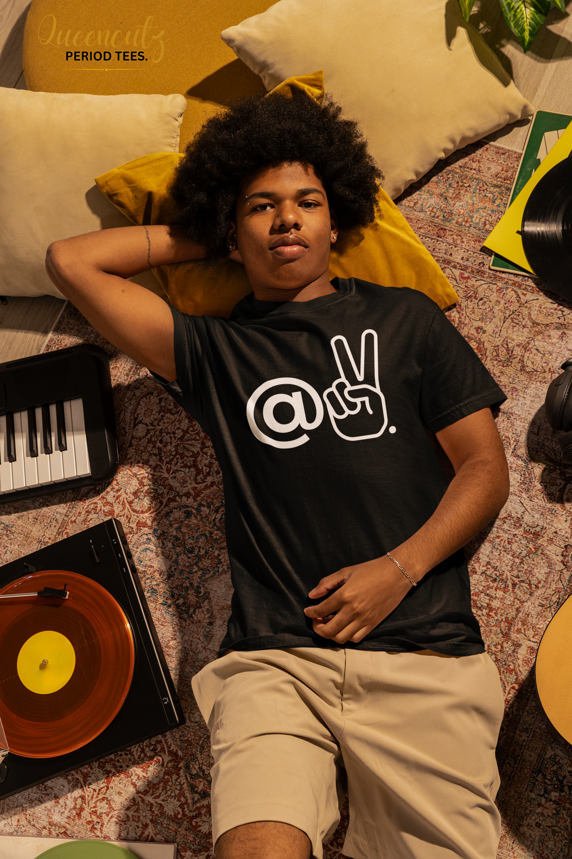 comfort-colors-tee-mockup-featuring-a-man-resting-on-the-floor-surrounded-by-music-stuff-m56617.png