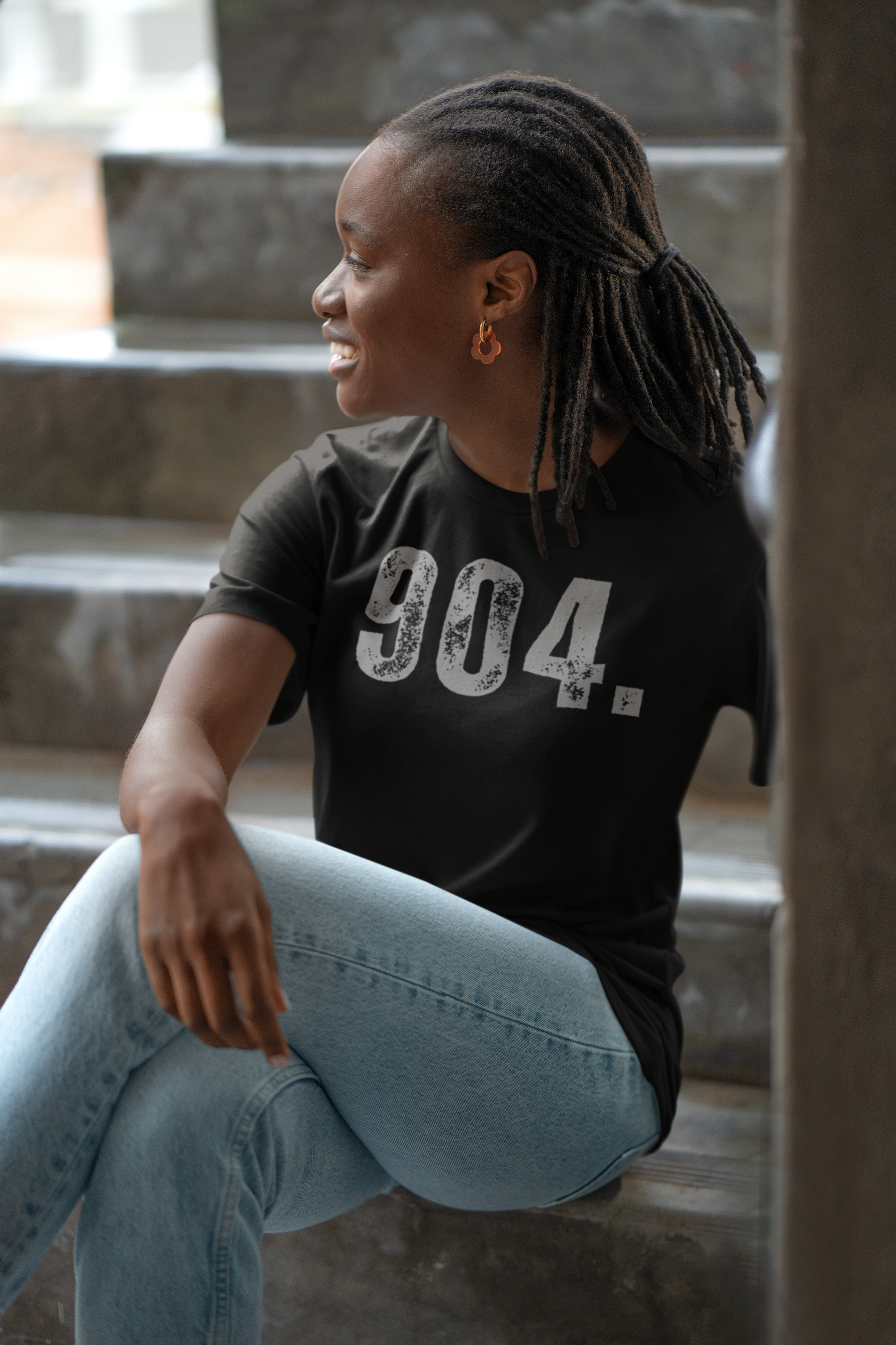 bella-canvas-mockup-featuring-a-smiling-woman-wearing-a-t-shirt-and-sitting-on-a-staircase-m39807.png