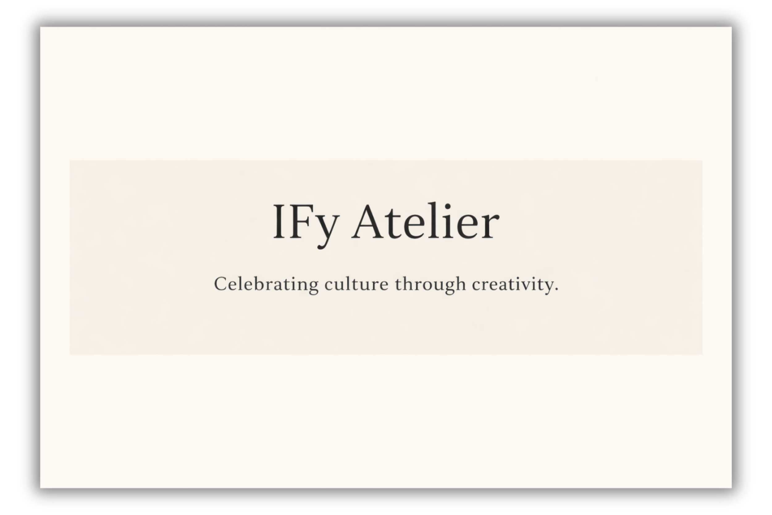 Close-up of a sign with black text that reads 'Ify Atelier Celebrating culture through creativity' on a white background