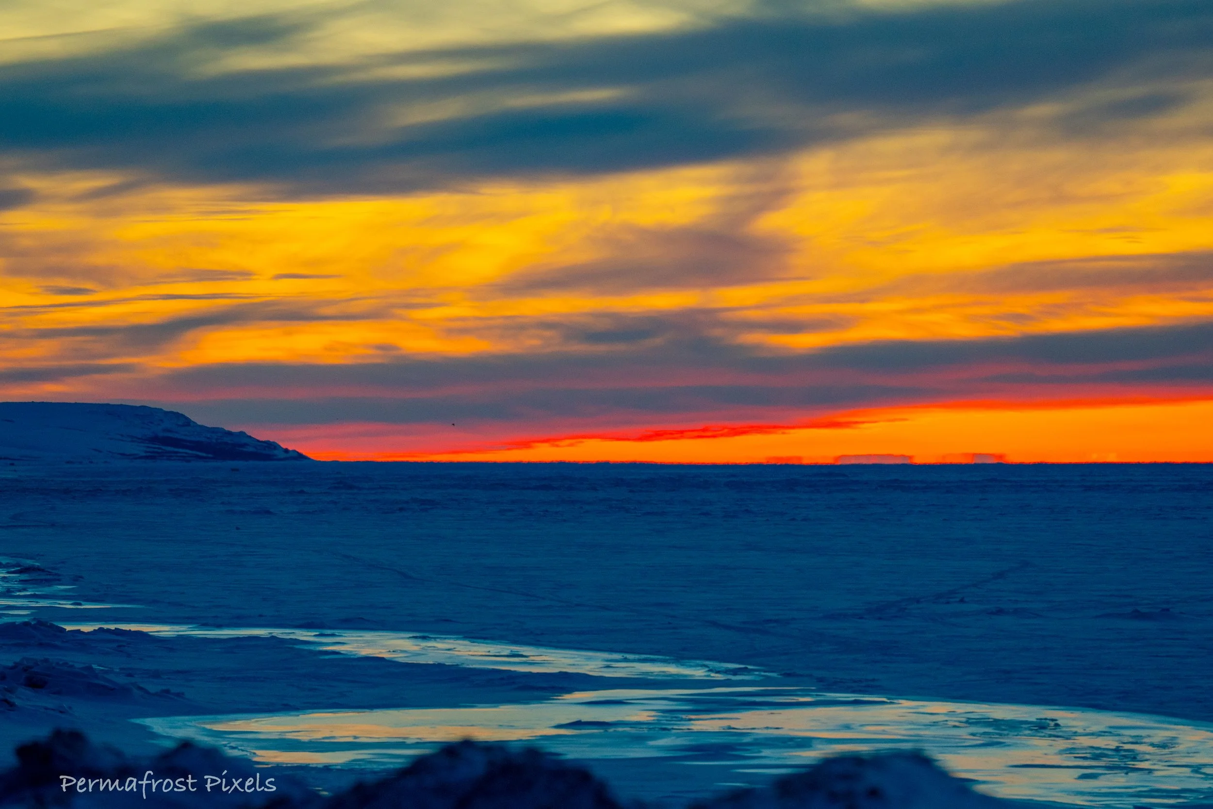 Arctic tundra landscape in Nome Alaska at golden hour with Cape Nome and the Bering Sea Ice