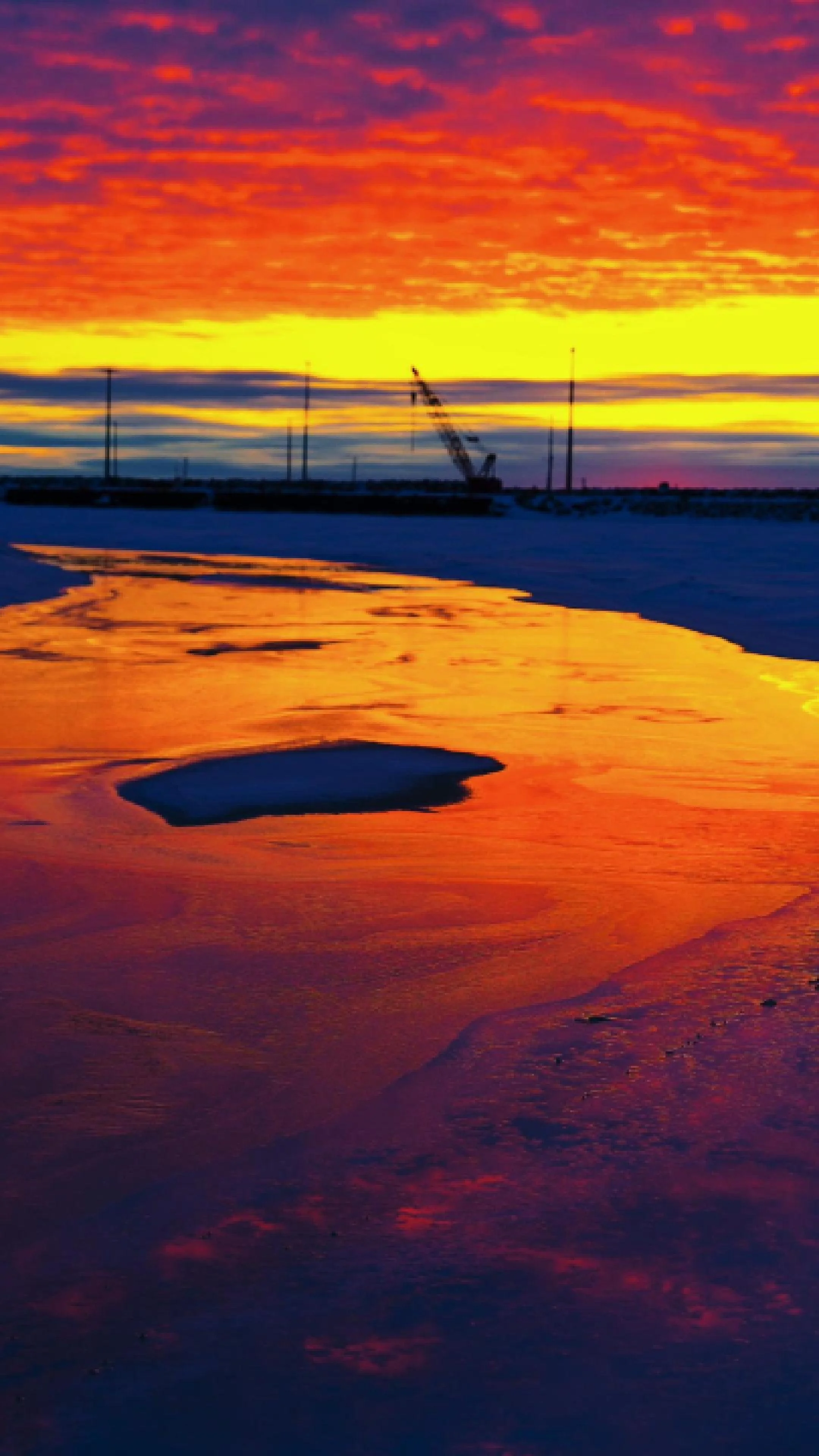 A sunset I will never forget.  Vibrant Arctic sunset over the Port of Nome causeway and breakwater in Nome, Alaska.