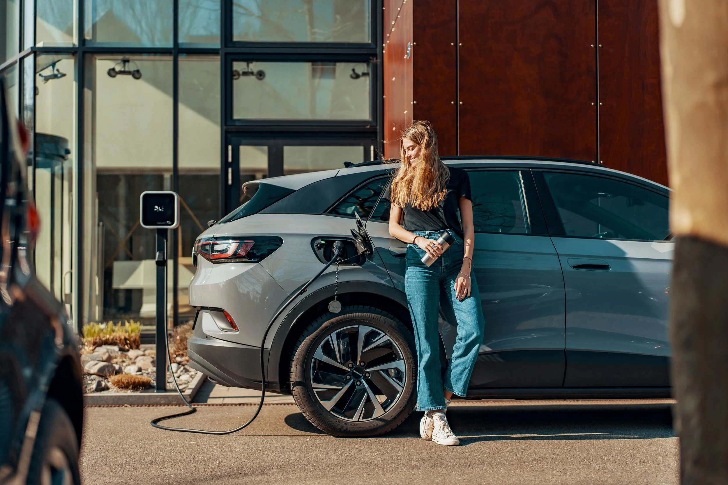 Woman happy with electric vehicle charging engine coolants