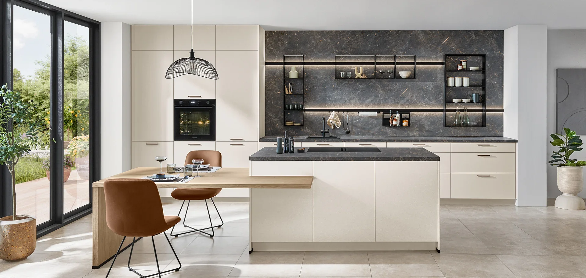 Modern kitchen with white cabinets, black countertops, and a dark marble backsplash, near large glass sliding doors leading to a garden.