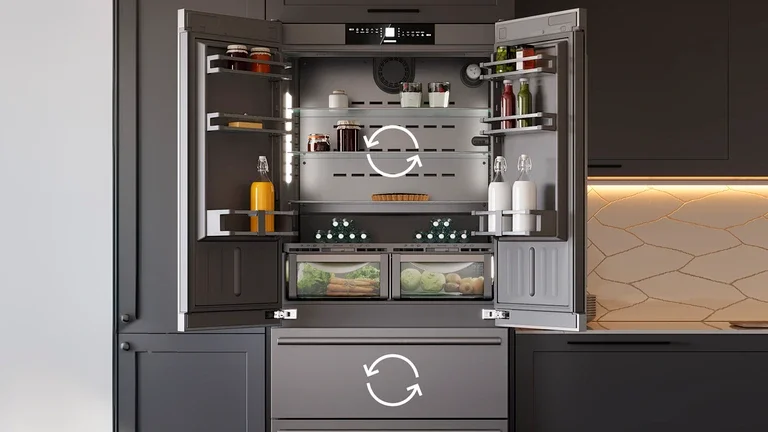 Open kitchen refrigerator with shelves containing bottles, jars, and food items, with lights inside, set in a modern kitchen with dark cabinets.
