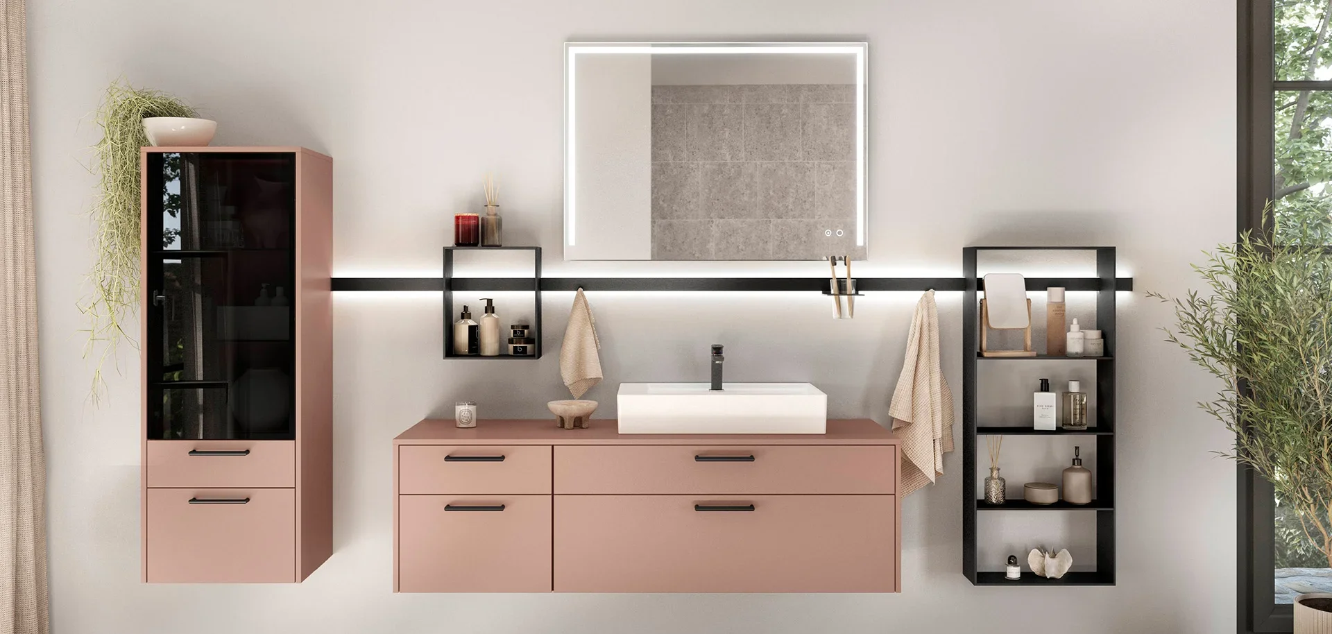 Modern bathroom vanity with a pink cabinet, black metal shelves, a white washbasin, and a backlit mirror, with decorative items and a large window with greenery outside.