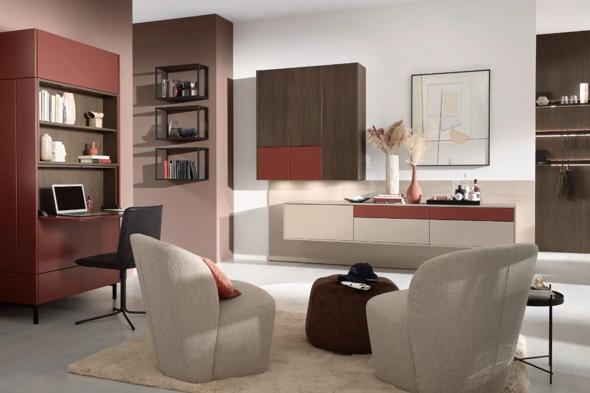 Contemporary living room with beige and brown furniture, wall shelving, and decorative vases.