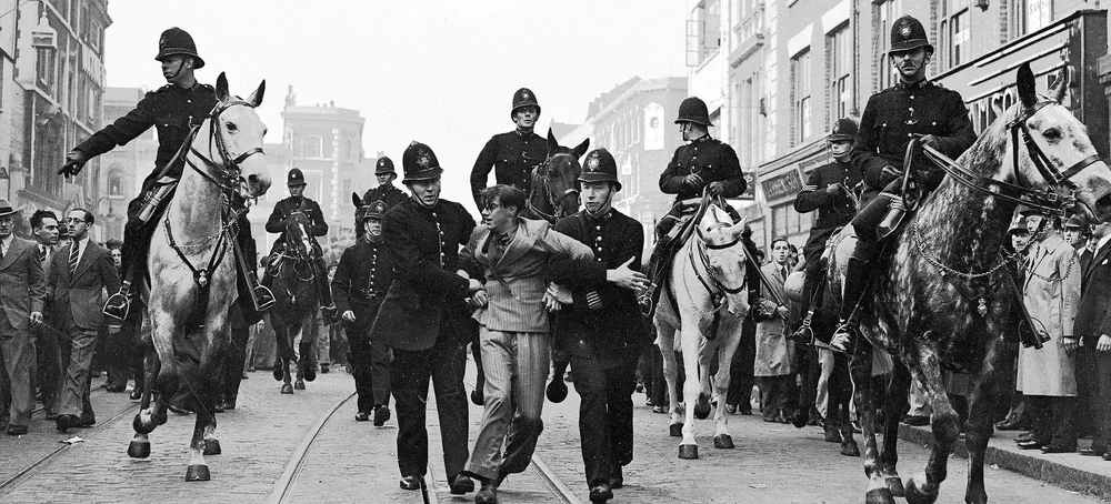 Protesters clash with police during the Battle of Cable Street.