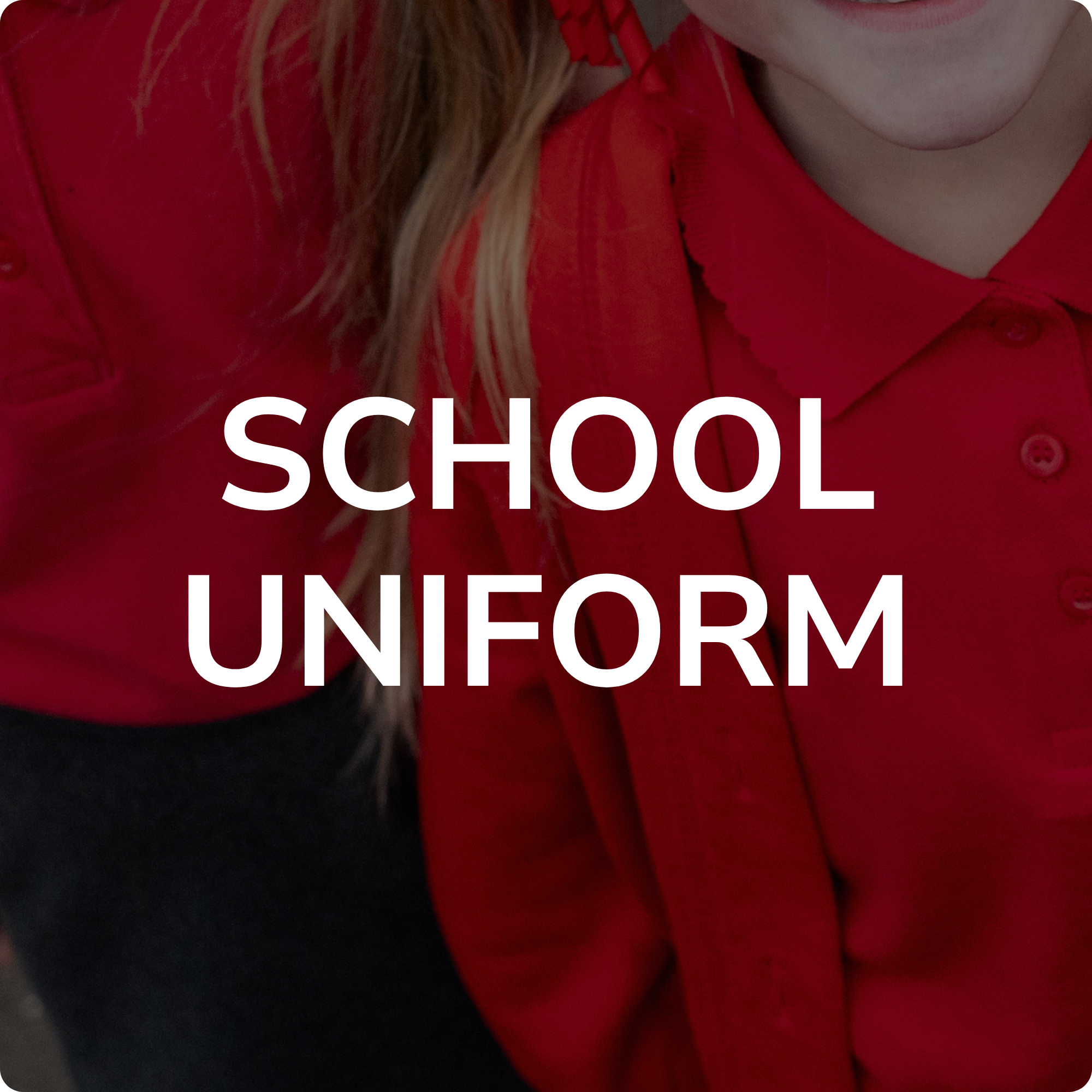 Close-up of a person wearing a red shirt with large white text that says 'SCHOOL UNIFORM'.