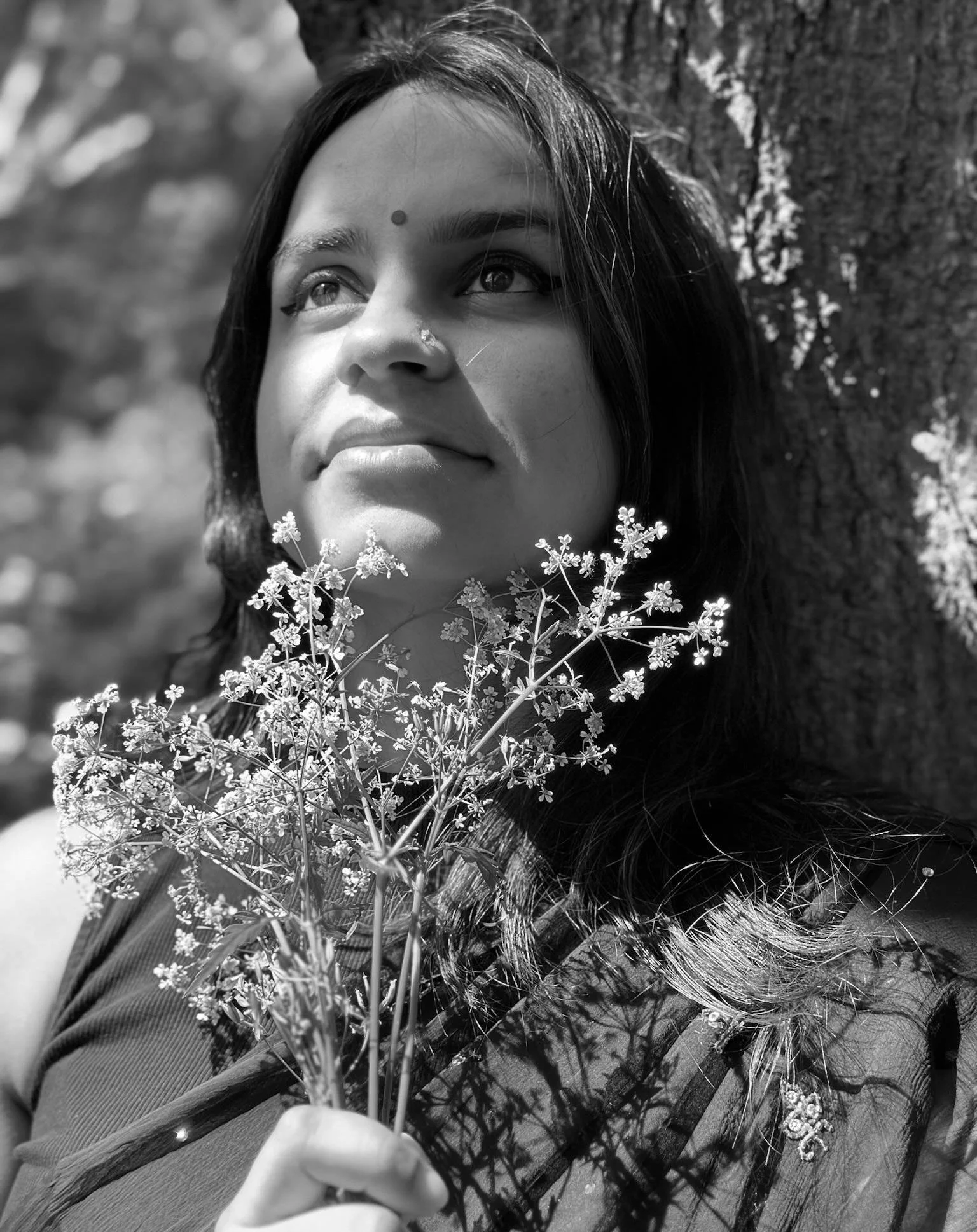 Tarini Tripathi headshot holding flowers in black and white