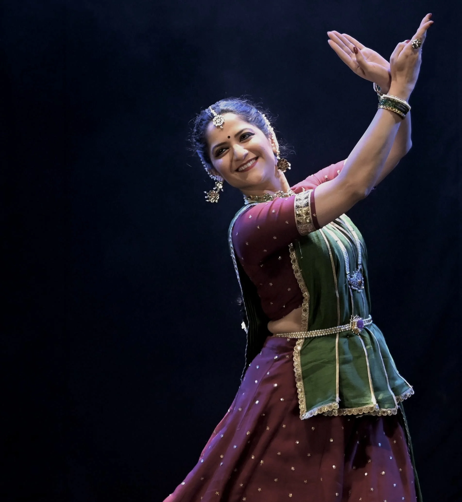 Sharvari Bhide Limaye performing Kathak on stage, wearing traditional costume, photographed by Kaustubh Atre.