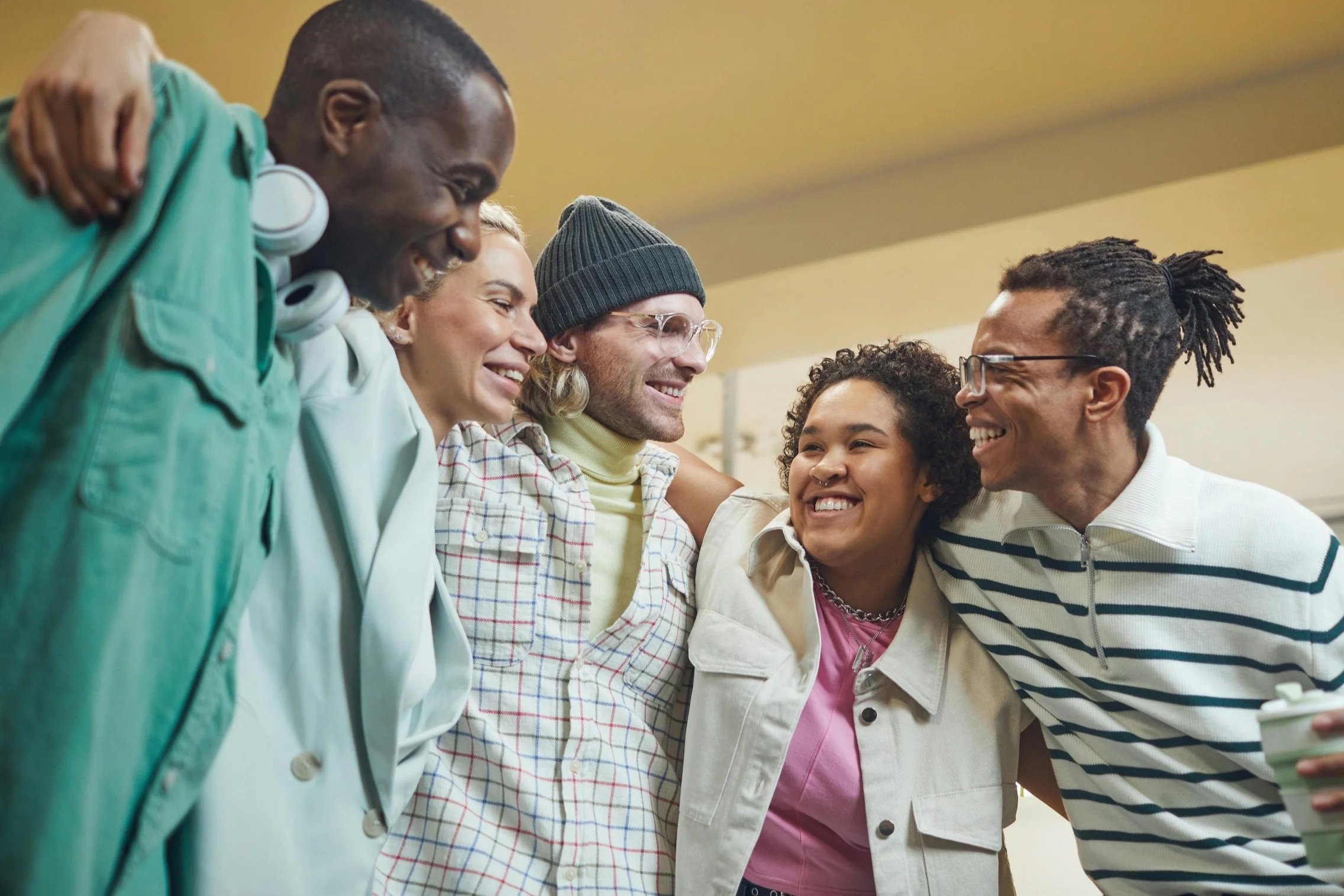 Diverse group of neurodivergent individuals smiling together at Brightmane Therapeutic Center San Jose.