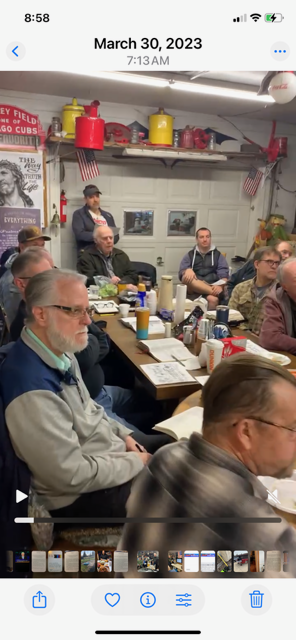 Group of men sitting encouraging one another at the farm.