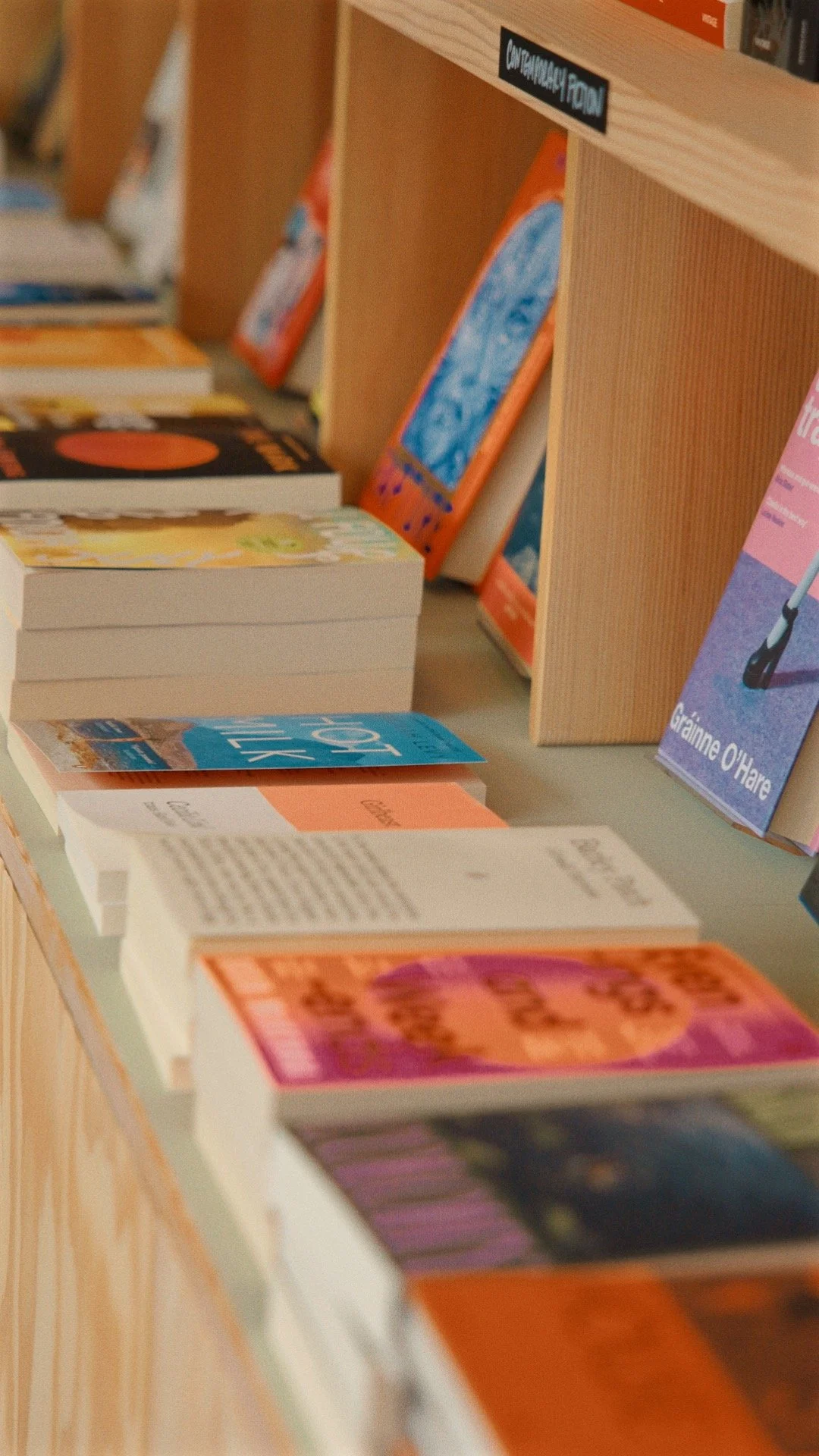 Books and brochures displayed on a table at a bookstore or library.
