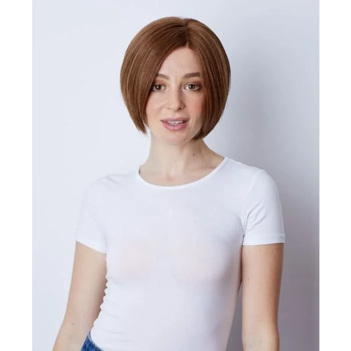 Young woman with short auburn hair wearing a white t-shirt against a plain white background.