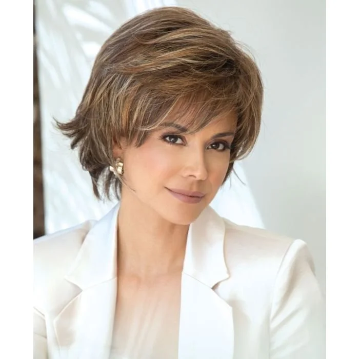 A woman with short, layered brown hair, wearing a white blazer and earrings, looking at the camera with a soft smile.
