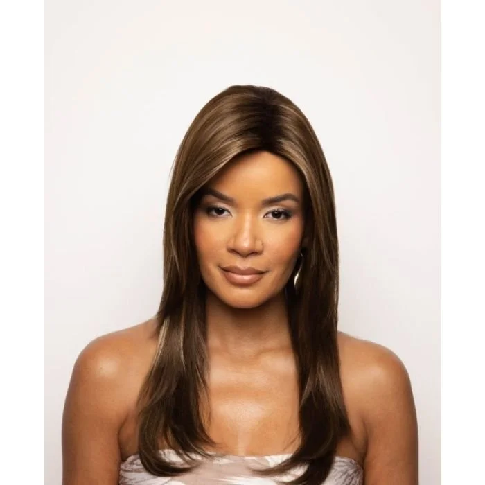 A woman with long, straight, light brown hair styled with a center part. She has light makeup, hoop earrings, and a neutral expression. She is wearing a strapless top and is posed against a plain white background.