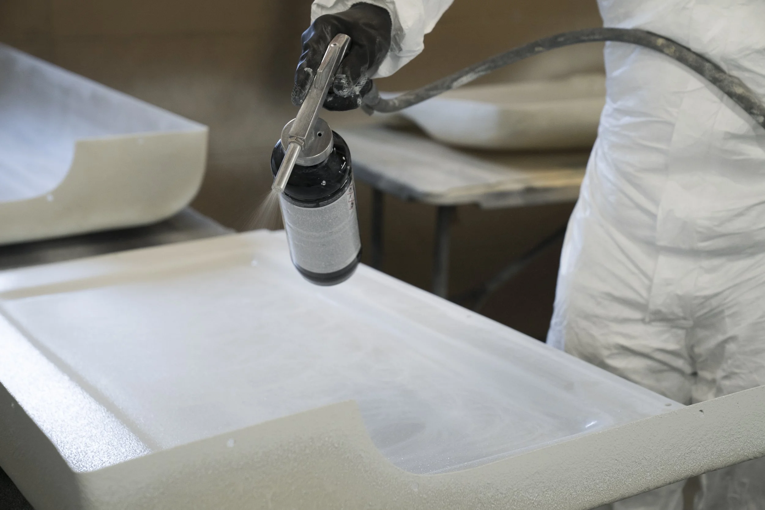 Spray painting a land rover interior trim to apply bespoke finish.